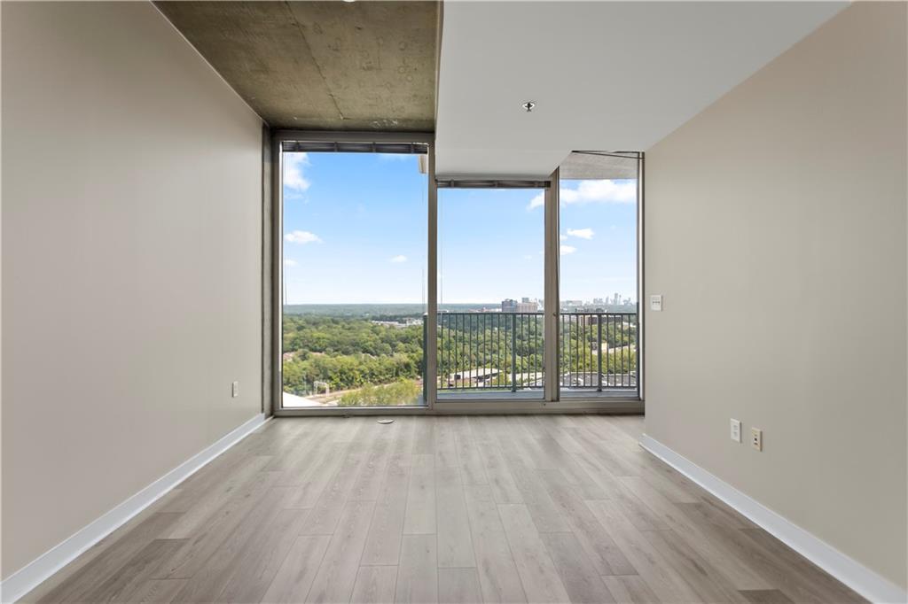 361 17th Street Northwest, Unit 1906 Atlanta, GA 30363 - Photo 10 of 28 an empty room with wooden floor and windows