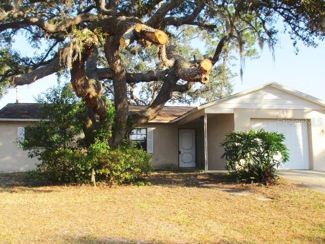 9149 Eldridge Road Spring Hill, FL 34608 - Photo 1 of 1 a view of a house with a yard