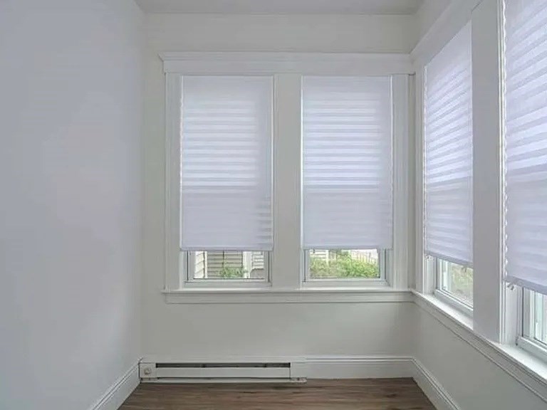 27 Hosmer Street, Unit 2 Boston, MA 02126 - Photo 12 of 20 a view of an empty room with wooden floor and a window
