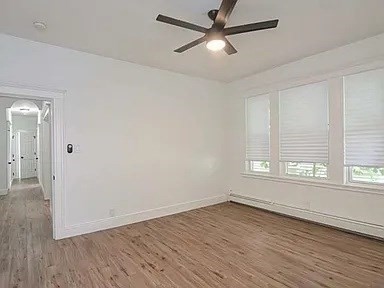 27 Hosmer Street, Unit 2 Boston, MA 02126 - Photo 16 of 20 an empty room with wooden floor fan and windows