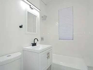 27 Hosmer Street, Unit 2 Boston, MA 02126 - Photo 7 of 20 a bathroom with a sink a toilet and shower