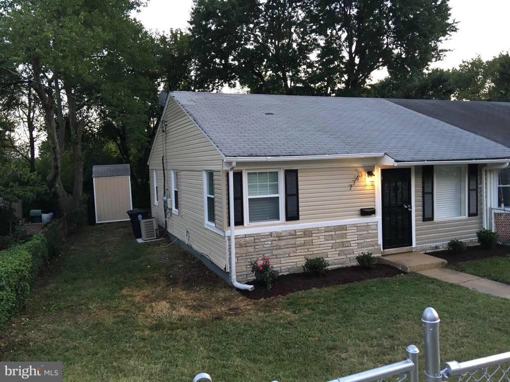 7743 Normandy Road Landover, MD 20785 - Photo 2 of 15 a front view of a house with a garden