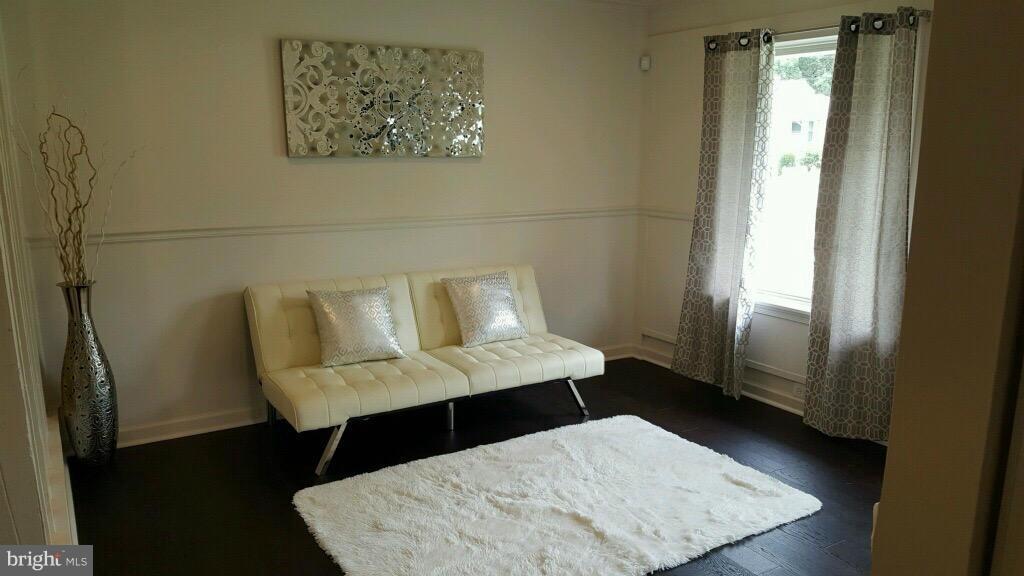 7743 Normandy Road Landover, MD 20785 - Photo 3 of 15 a view of a bedroom with furniture and wooden floor