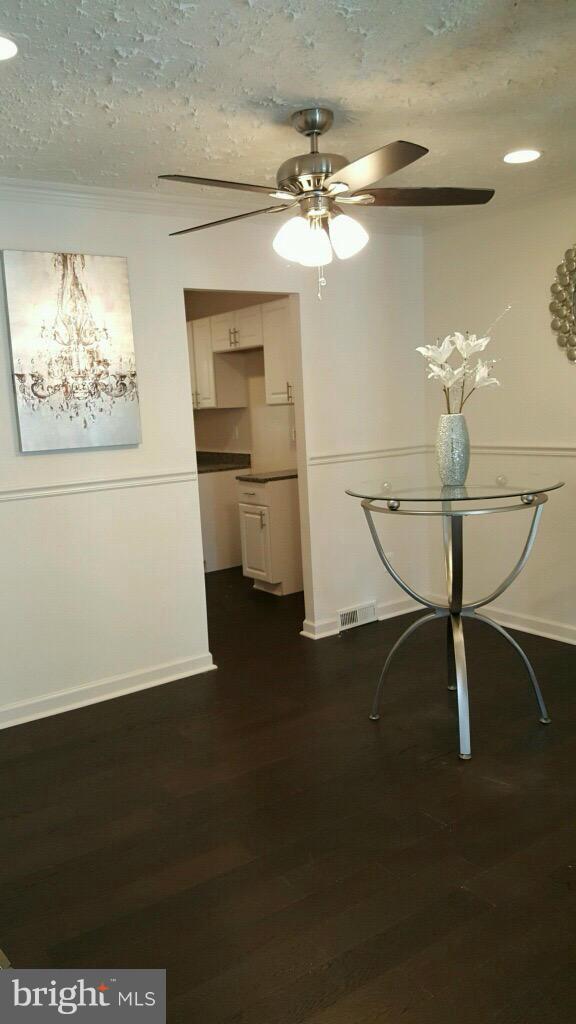 7743 Normandy Road Landover, MD 20785 - Photo 5 of 15 a view of a chandelier fan and wooden floor