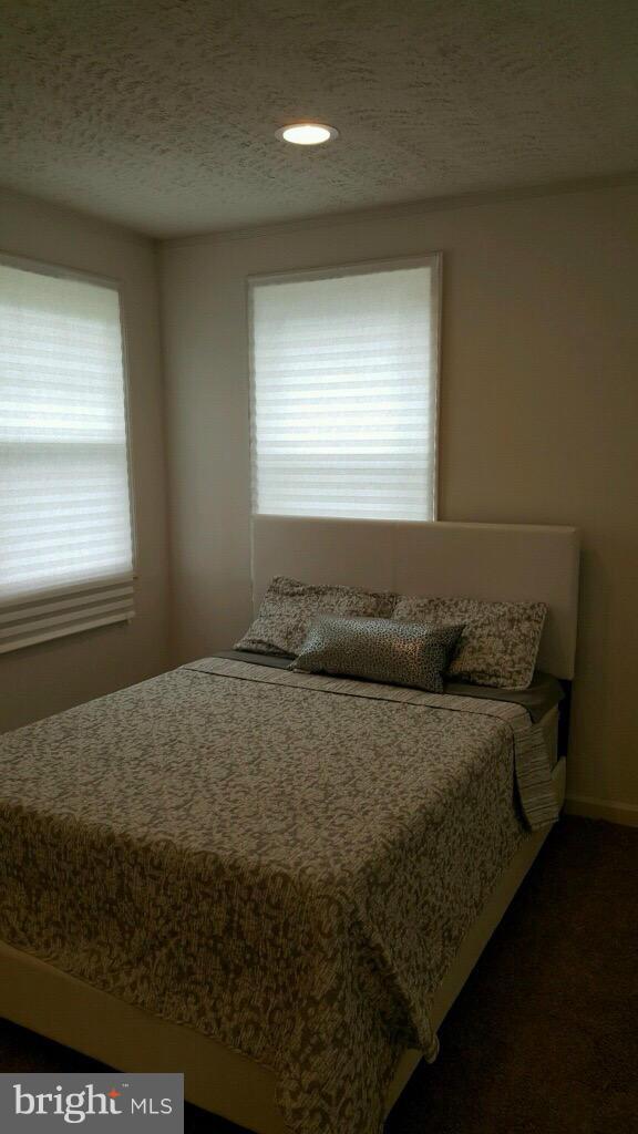 7743 Normandy Road Landover, MD 20785 - Photo 8 of 15 a bed sitting in a bedroom next to a window