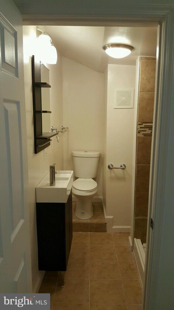 7743 Normandy Road Landover, MD 20785 - Photo 9 of 15 a bathroom with a toilet sink and mirror
