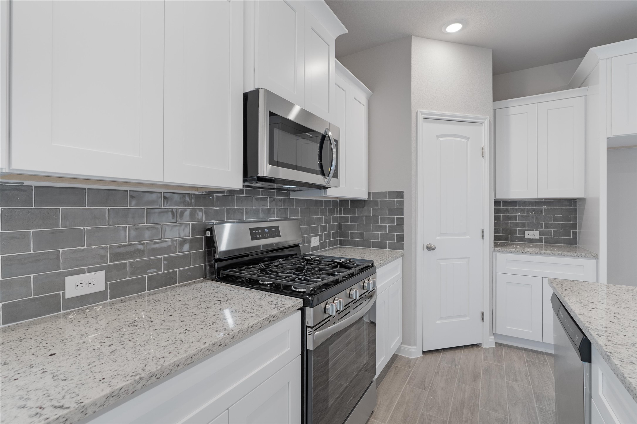 340 Stellar Wind Drive Georgetown, TX 78628 - Photo 11 of 31 a kitchen with stainless steel appliances granite countertop a stove a microwave and a sink