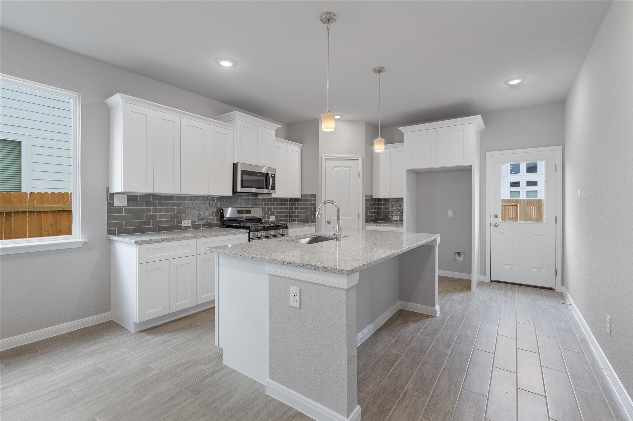 340 Stellar Wind Drive Georgetown, TX 78628 - Photo 2 of 31 a kitchen with a sink stove and refrigerator