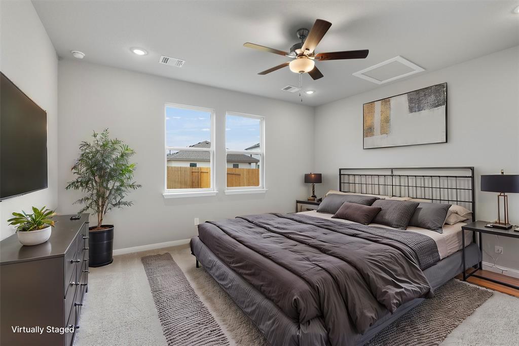 340 Stellar Wind Drive Georgetown, TX 78628 - Photo 5 of 31 a bedroom with bed and a potted plant