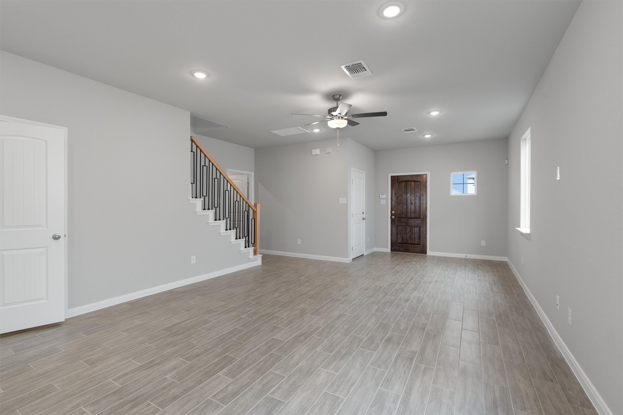 340 Stellar Wind Drive Georgetown, TX 78628 - Photo 9 of 31 a view of an empty room with wooden floor and a ceiling fan