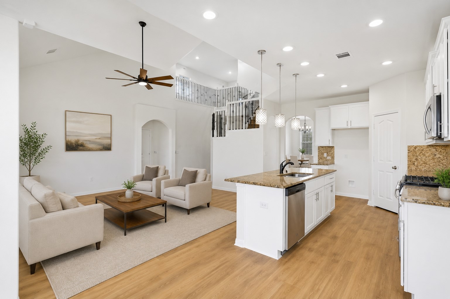 304 Santa Maria Street Georgetown, TX 78628 - Photo 16 of 37 An inviting open-concept space features vaulted ceilings, a well-appointed kitchen island, and hardwood flooring throughout. Virtually Staged.