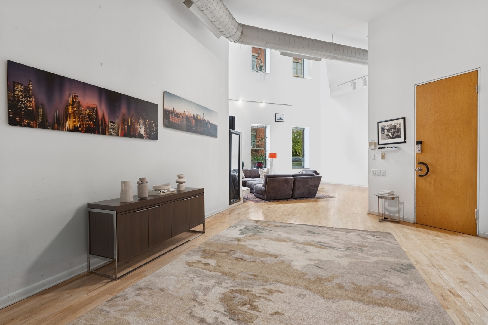 711 North Milwaukee Avenue, Unit 2 Chicago, IL 60642 - Photo 12 of 27 a living room with furniture and a flat screen tv