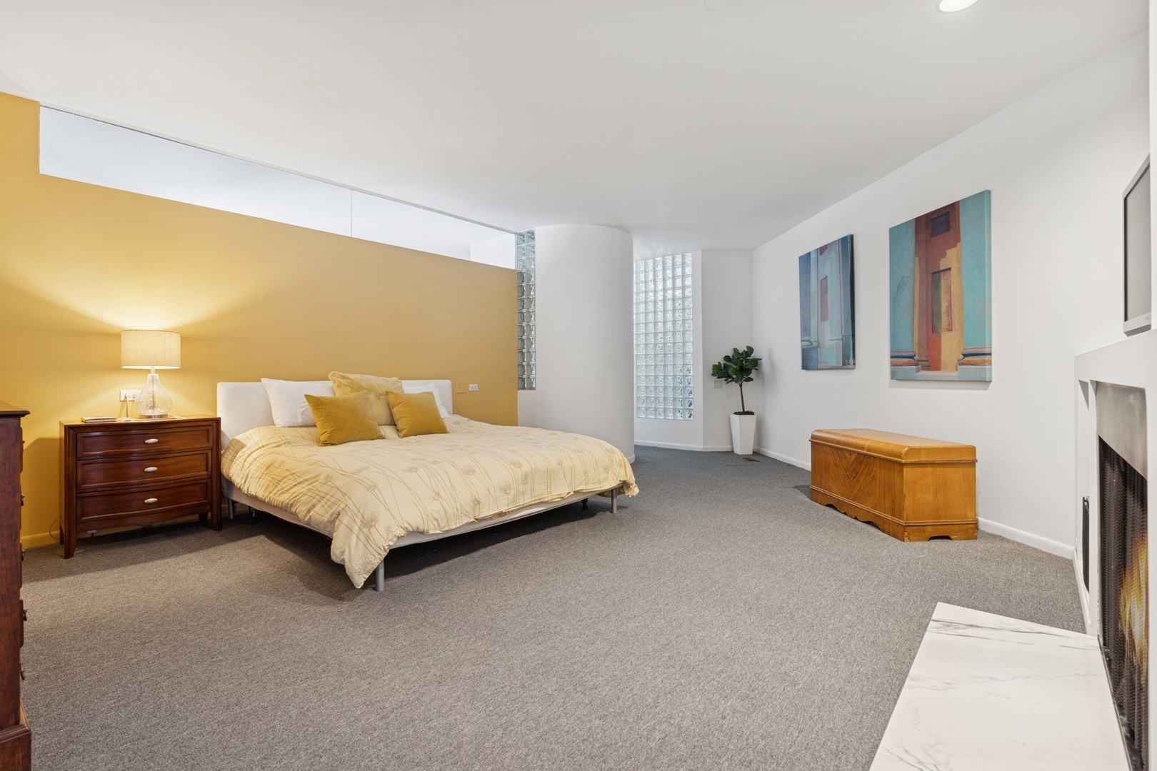 711 North Milwaukee Avenue, Unit 2 Chicago, IL 60642 - Photo 14 of 27 a bedroom with a bed and a night stand