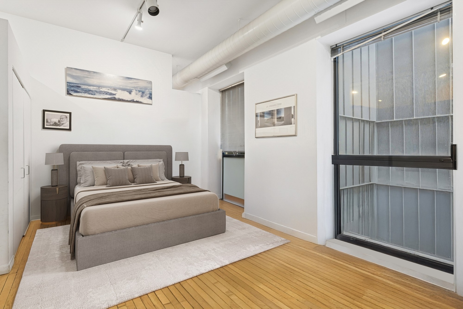 711 North Milwaukee Avenue, Unit 2 Chicago, IL 60642 - Photo 18 of 27 a bedroom with a large bed and a chandelier