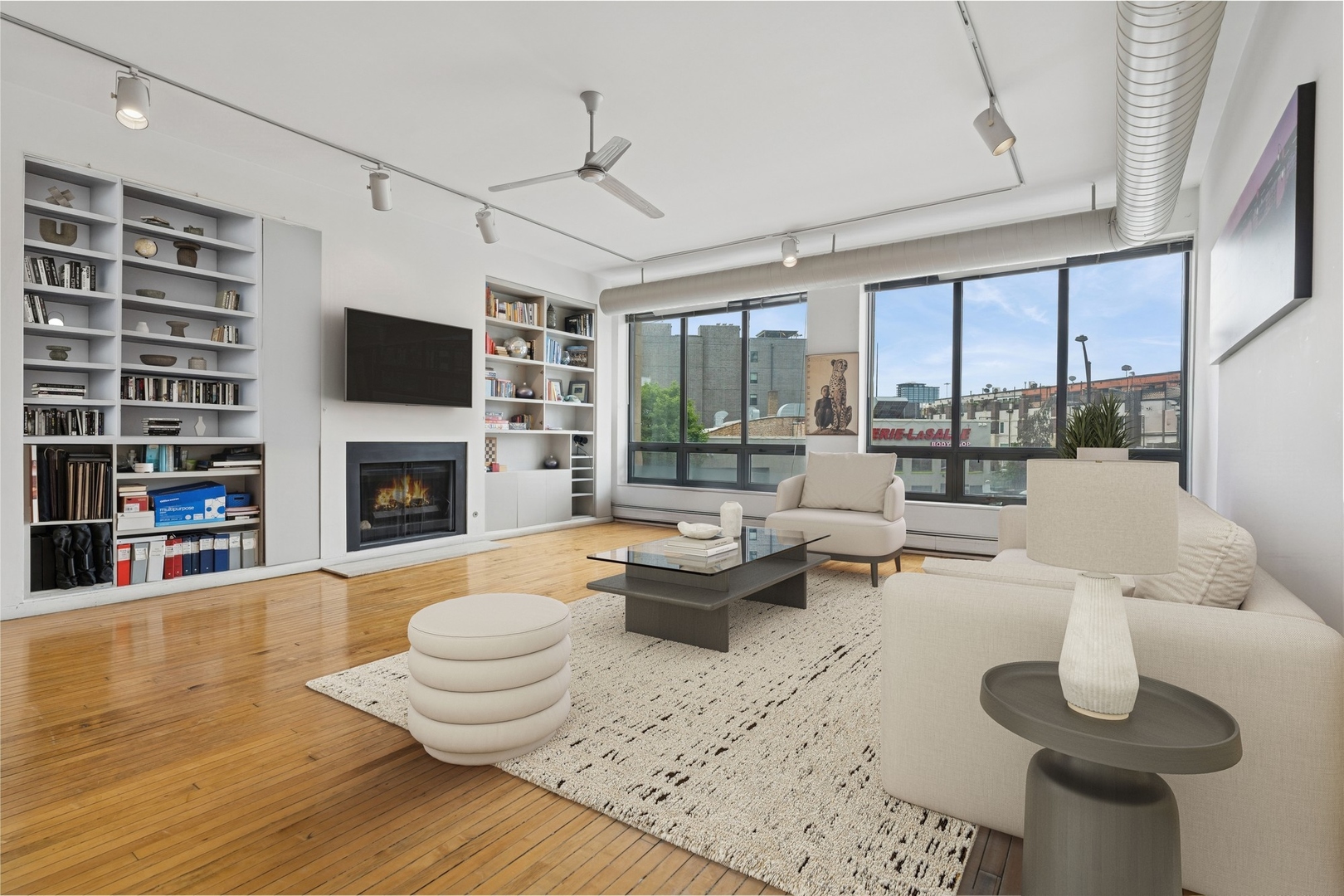 711 North Milwaukee Avenue, Unit 2 Chicago, IL 60642 - Photo 2 of 27 a living room with furniture fireplace and a large window