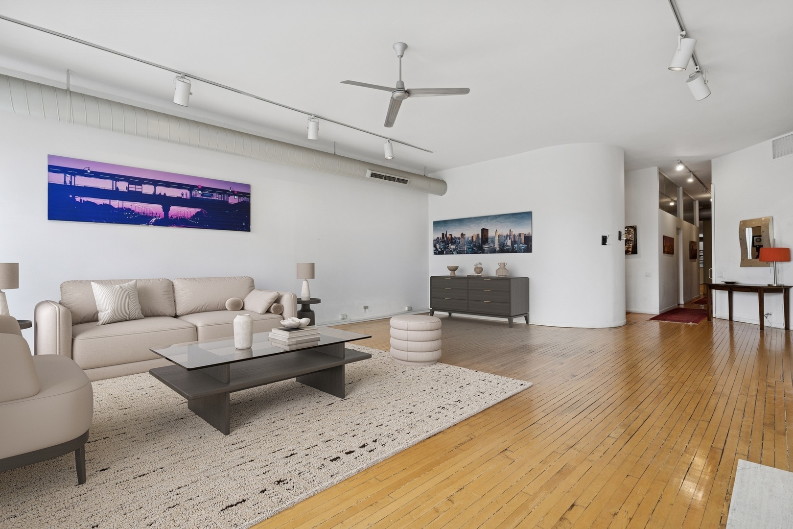 711 North Milwaukee Avenue, Unit 2 Chicago, IL 60642 - Photo 4 of 27 a living room with furniture and wooden floor