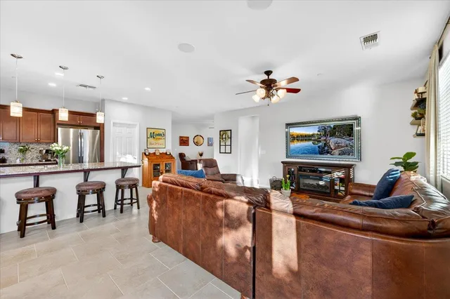 a bathroom with a granite countertop sink a toilet and a mirror
