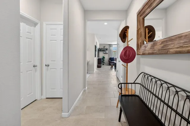 a living room with furniture a chandelier and a window