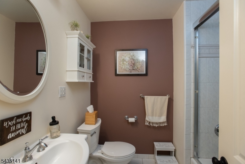 14 Locust Street Madison, NJ 07940 - Photo 12 of 33 a bathroom with a toilet a sink and mirror