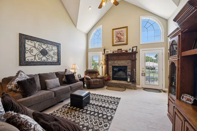 a dining room with furniture a chandelier and window