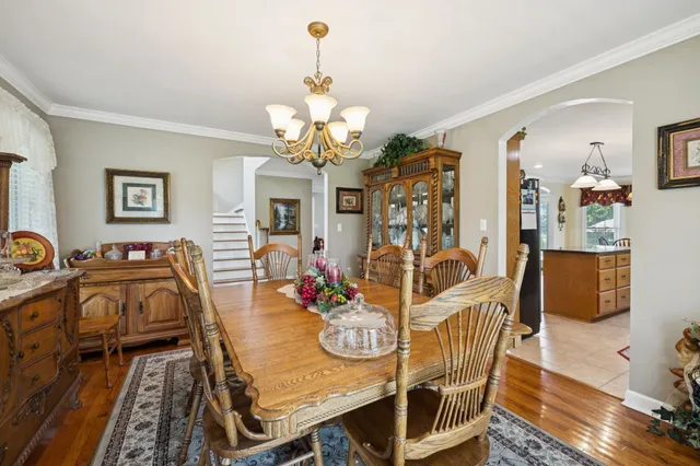 a living room with a bed furniture and a large window