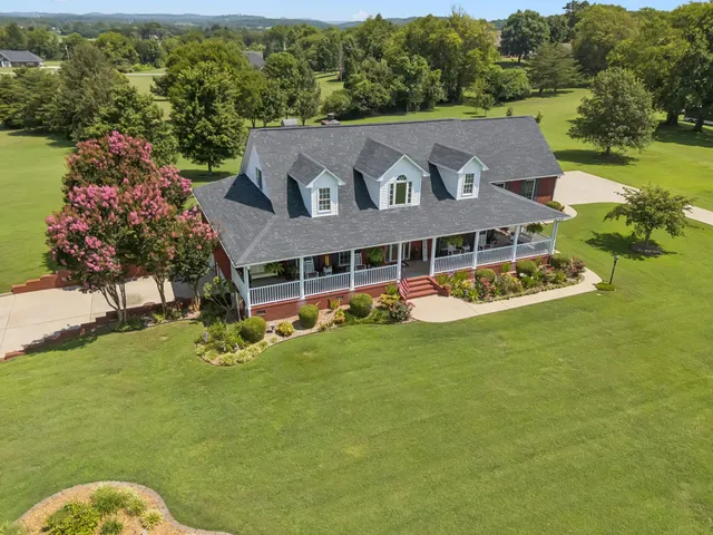 a view of a balcony with chairs and wooden fence