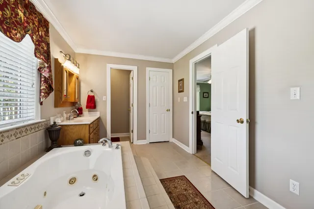 a bathroom with a granite countertop toilet sink and mirror