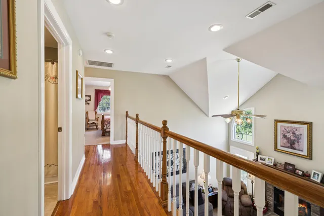 an aerial view of a house with a garden and lake view