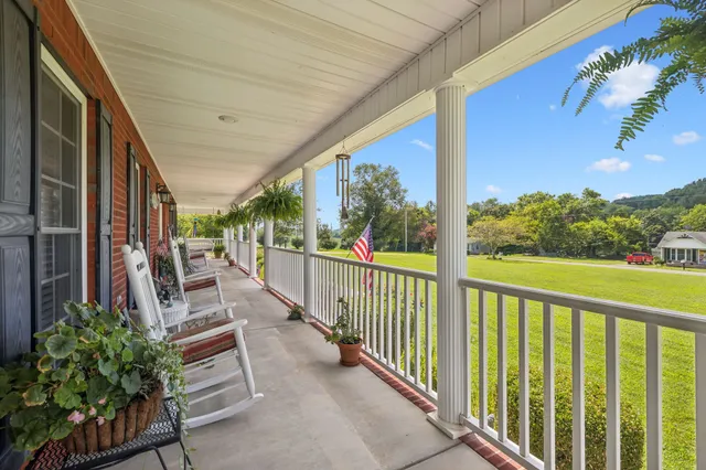 a living room with furniture ceiling fan and a rug