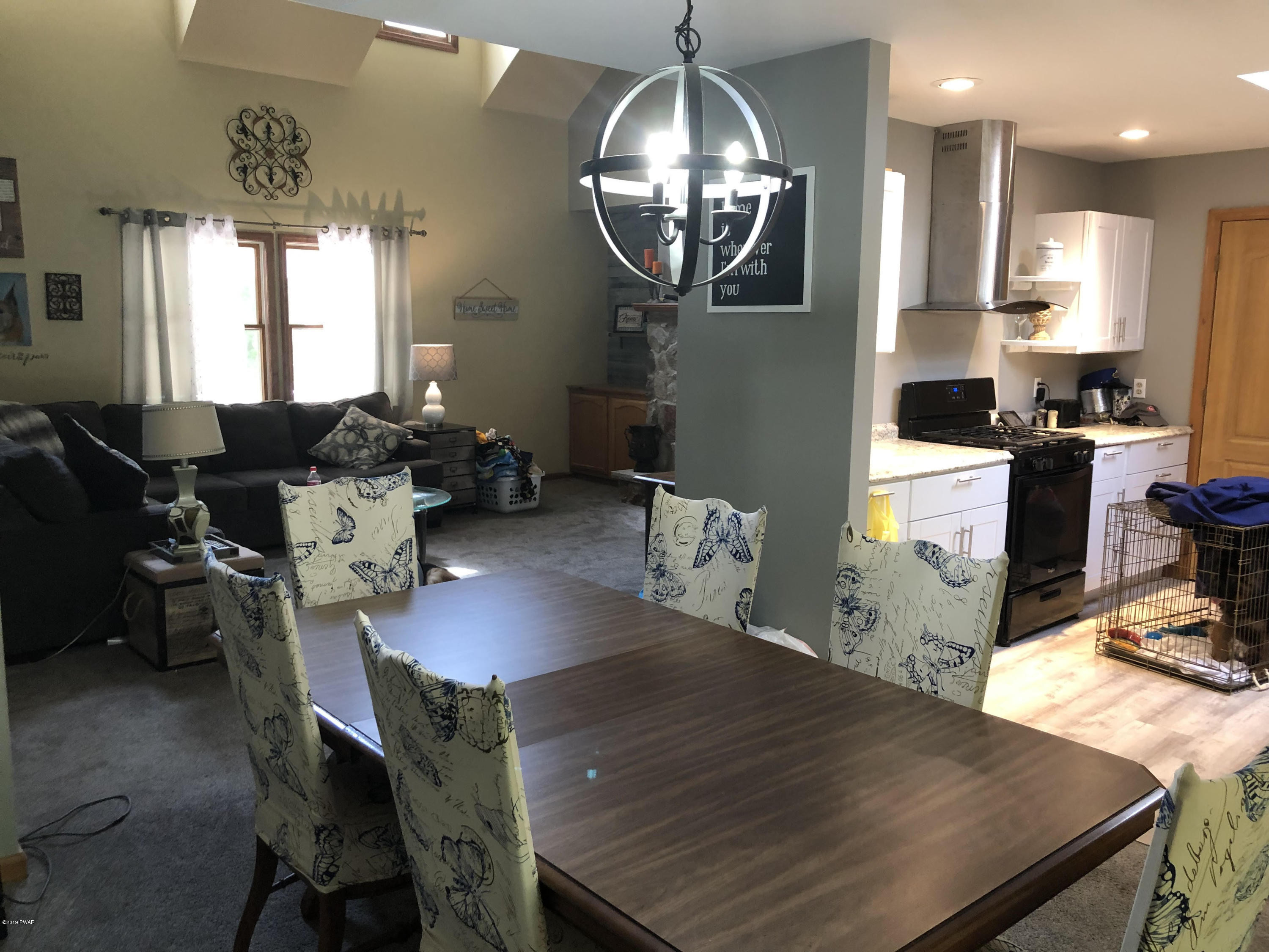 110 Weasel Road Dingmans Ferry, PA 18328 - Photo 23 of 39 a very nice looking dining room with kitchen island a table and chairs in it