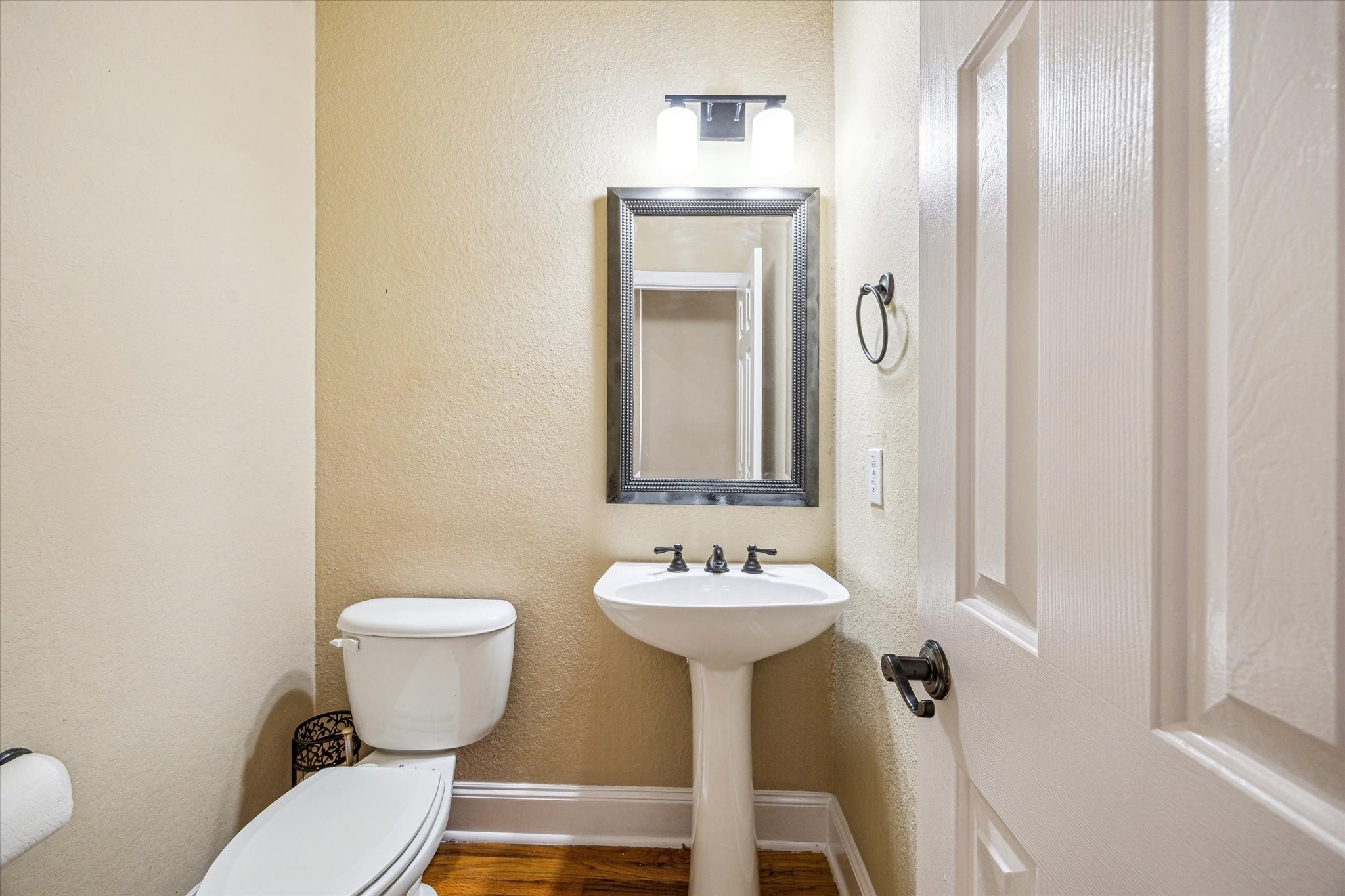 210 Grove Street Houston, TX 77020 - Photo 11 of 28 a bathroom with a sink and mirror with toilet