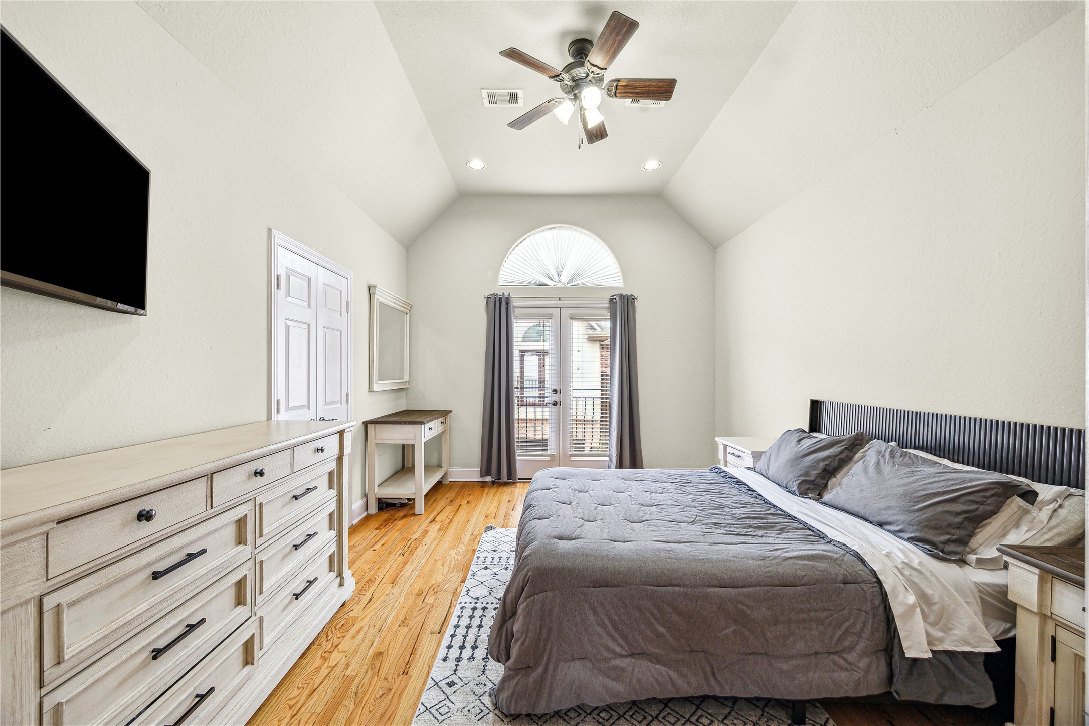 210 Grove Street Houston, TX 77020 - Photo 13 of 28 a spacious bedroom with a bed and a flat screen tv