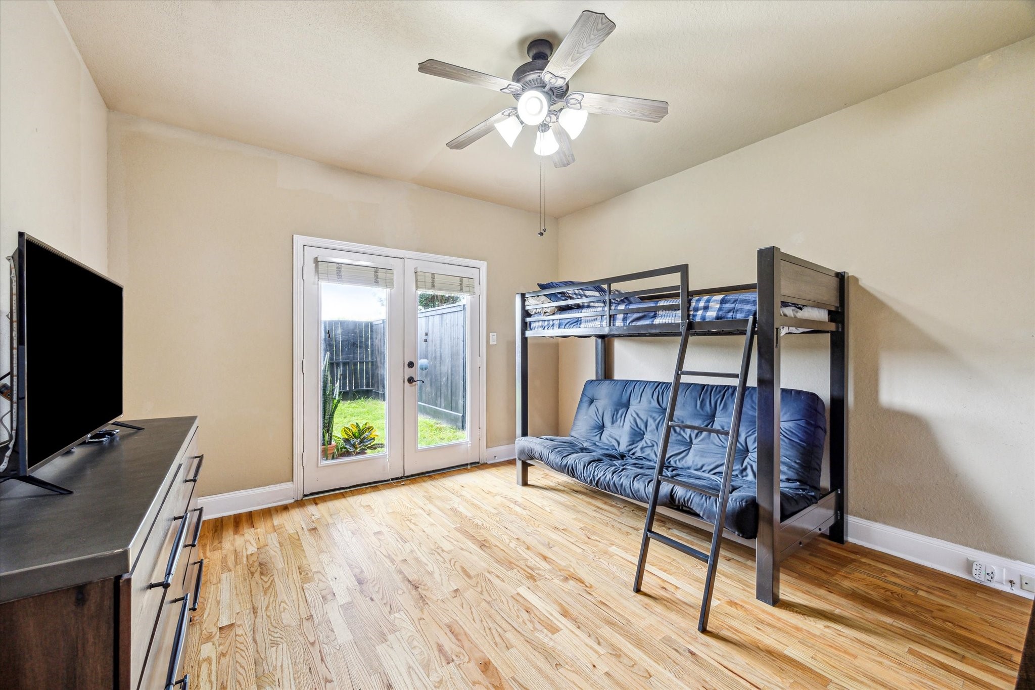 210 Grove Street Houston, TX 77020 - Photo 18 of 28 a bedroom with furniture and wooden floor
