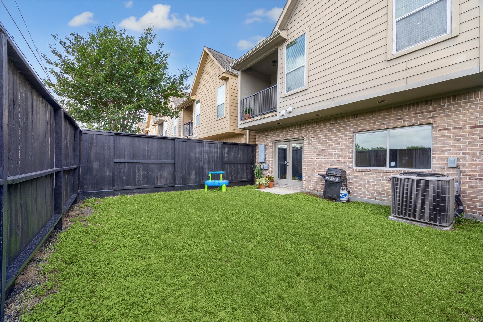 210 Grove Street Houston, TX 77020 - Photo 23 of 28 a view of a backyard with plants and wooden fence