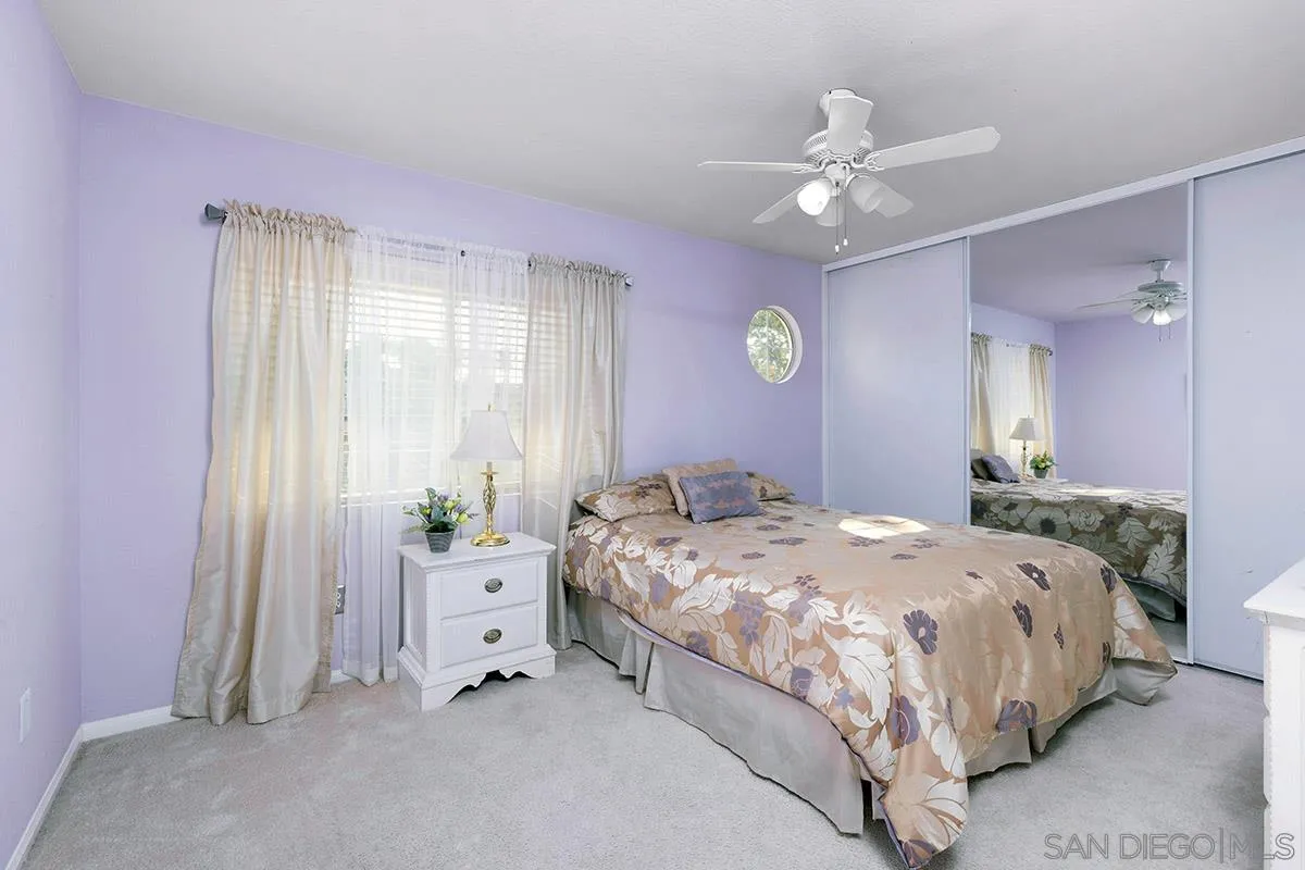 1690 West 11th Avenue Escondido, CA 92029 - Photo 21 of 25 a bedroom with a bed and a chandelier
