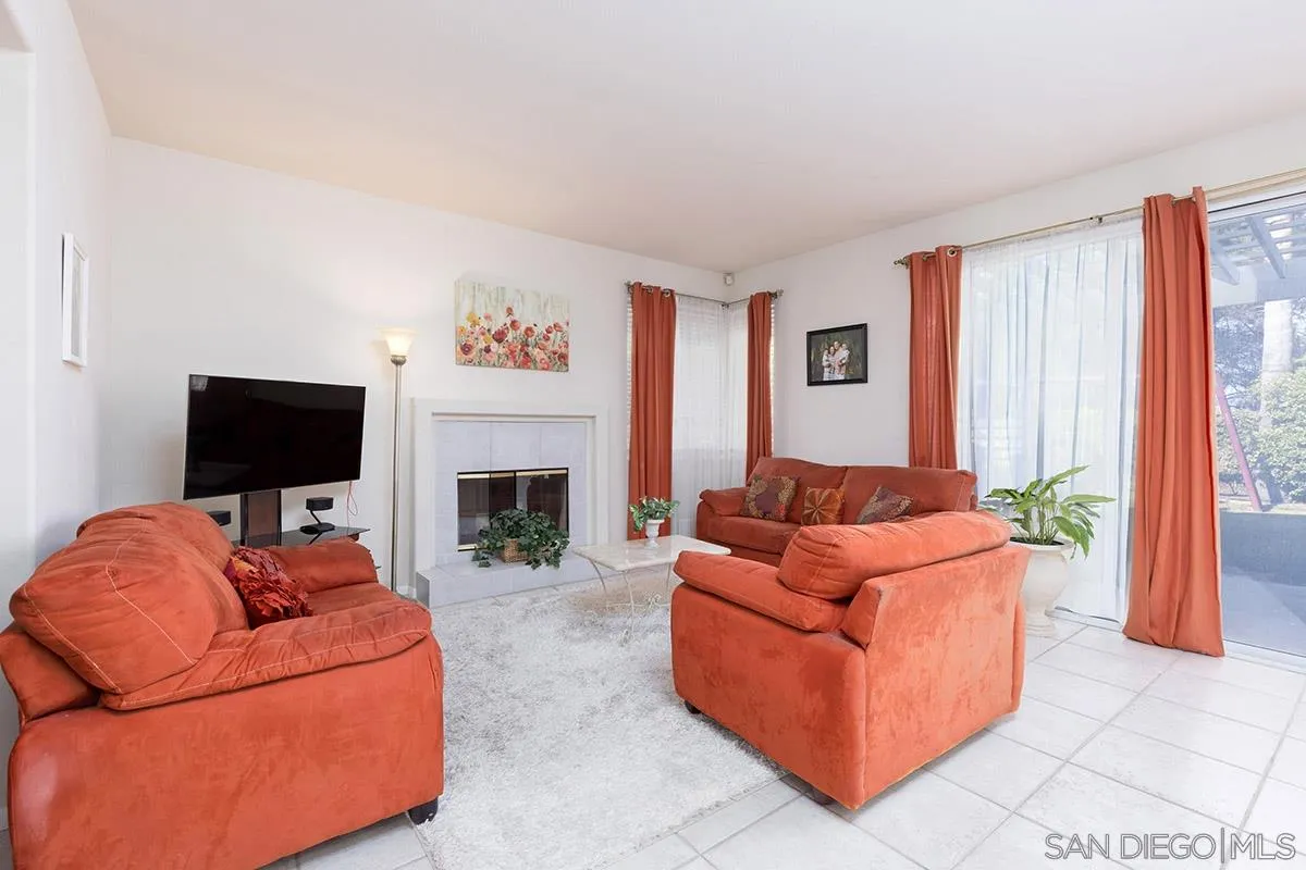 1690 West 11th Avenue Escondido, CA 92029 - Photo 6 of 25 a living room with furniture a flat screen tv and a fireplace