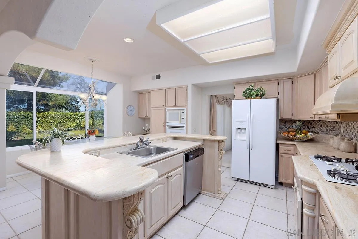1690 West 11th Avenue Escondido, CA 92029 - Photo 8 of 25 a kitchen that has a sink a refrigerator and a stove top oven
