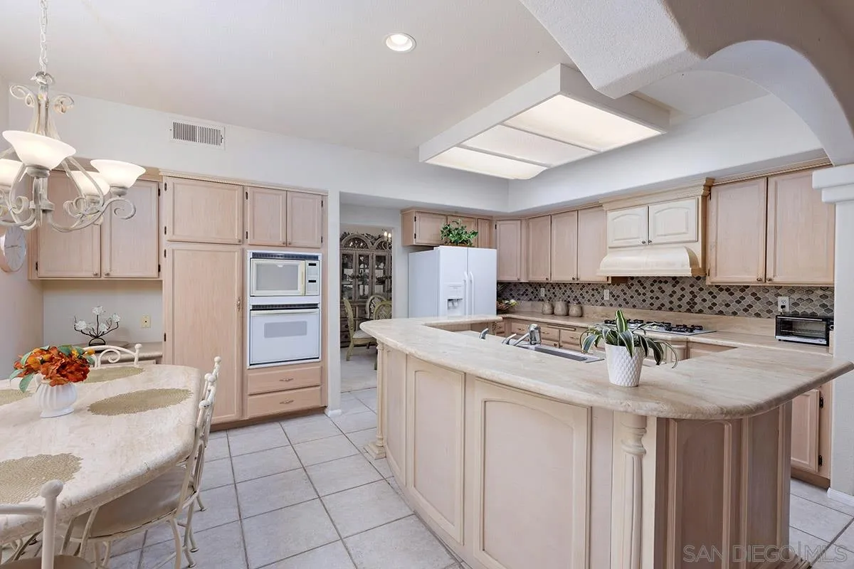 1690 West 11th Avenue Escondido, CA 92029 - Photo 9 of 25 a kitchen with stainless steel appliances a sink stove and refrigerator