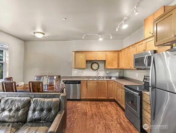 a kitchen with stainless steel appliances granite countertop a sink and stove top oven