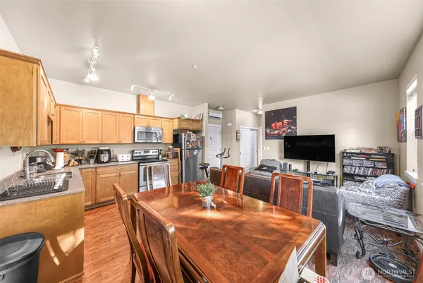 a open dining room with a table chairs and flat screen tv