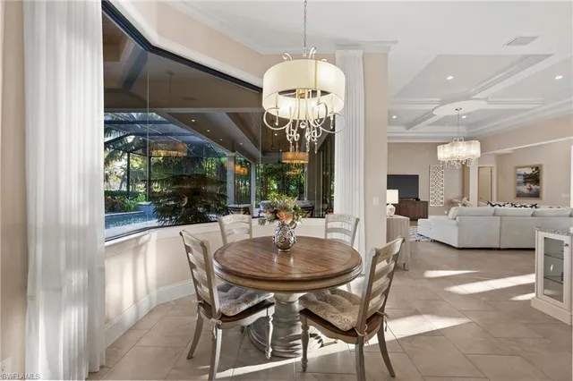 a view of a dining room with furniture and chandelier