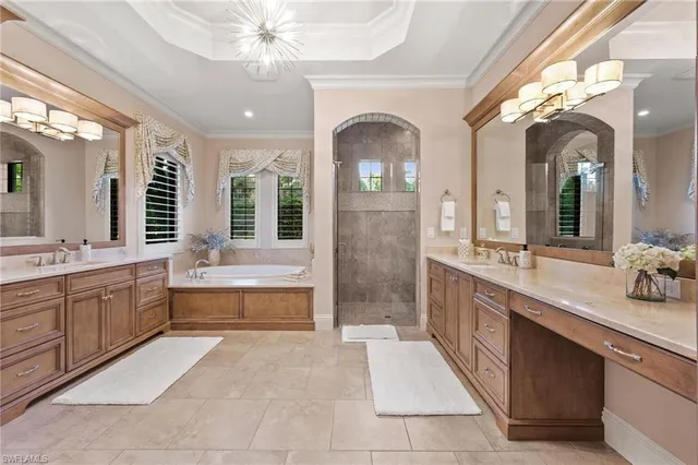 a large spacious bathroom with a granite countertop sink mirror and a bathtub