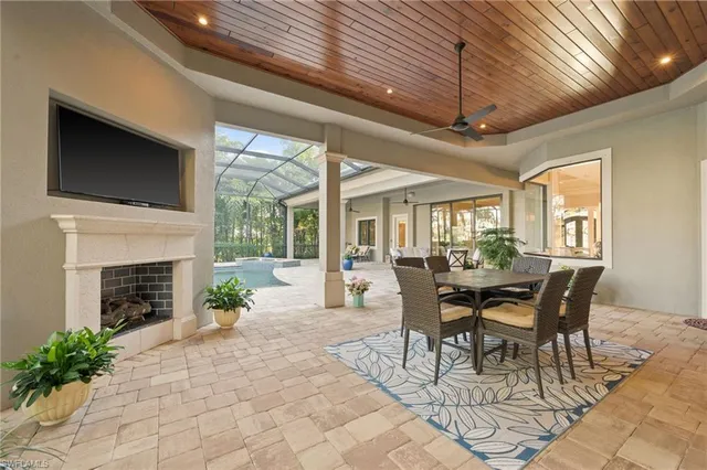 a living room filled with furniture and large windows