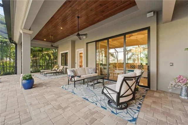 a view of a dining room with furniture large windows and wooden floor