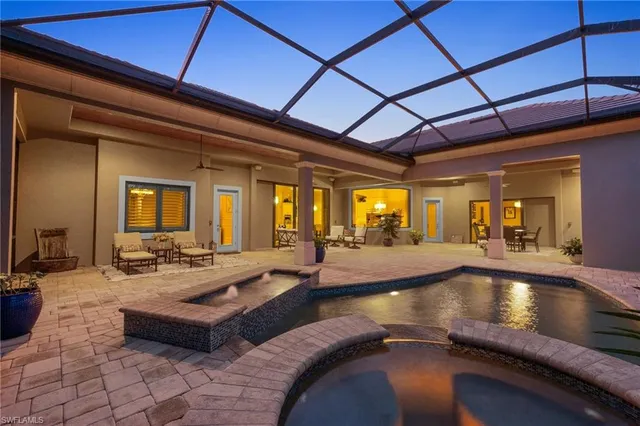 a view of swimming pool with seating area