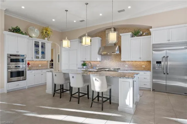 a large kitchen with a table and chairs in it
