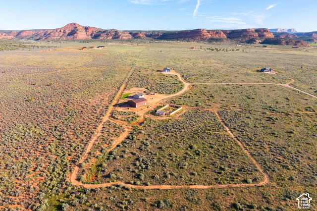 215 South Copper Road East Kanab, UT 84741 - Photo 41 of 41 Expansive property featuring multiple structures, unpaved access roads, a large barn, and a fenced enclosure