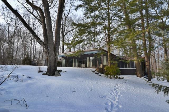92 Briscoe Road New Canaan, CT 06840 - Photo 1 of 1 a view of a house with a tree in the road