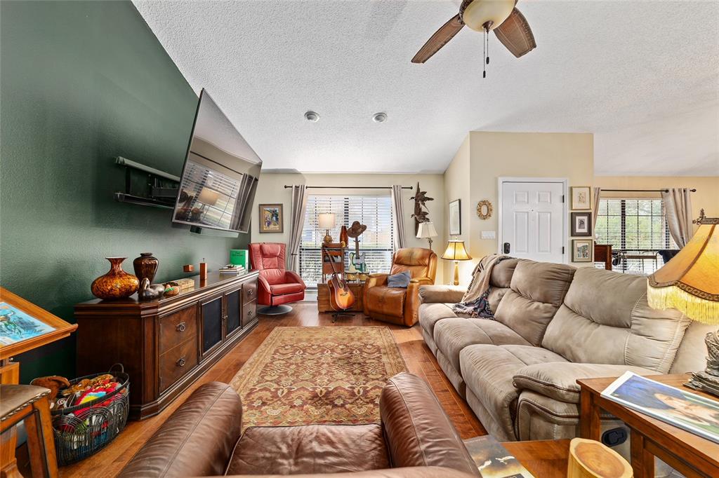 5030 Southeast 3rd Place Ocala, FL 34471 - Photo 16 of 45 a living room with furniture kitchen view and a wooden floor