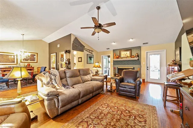 a living room with furniture fireplace and a table
